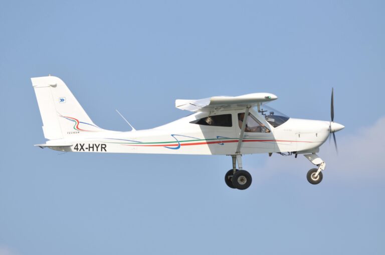 Light aircraft flying against clear blue sky in Israel.