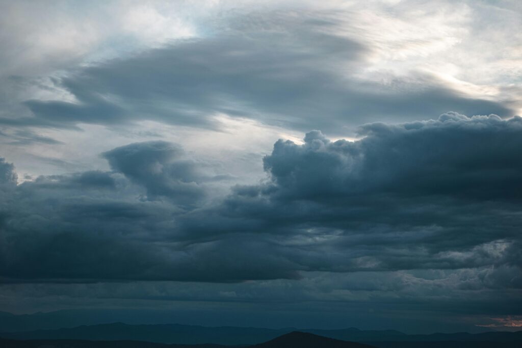 A captivating sky filled with dark, atmospheric clouds suggesting an impending storm.
