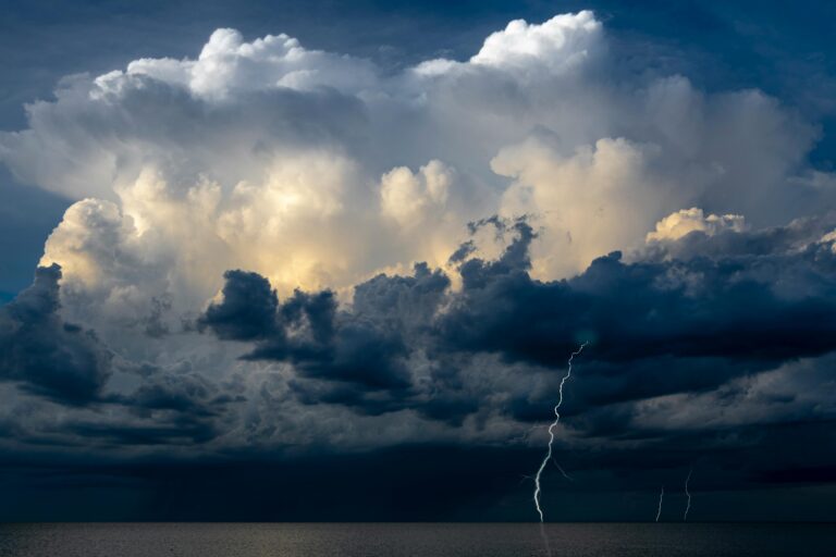 Captivating image of a thunderstorm with lightning strikes over the ocean, capturing nature's raw power.